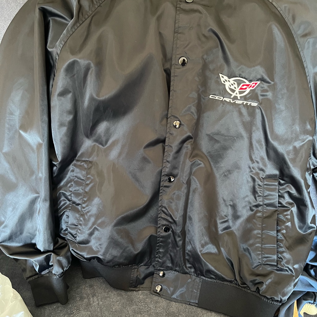 Sleek Black Bomber Jacket With Glossy Finish